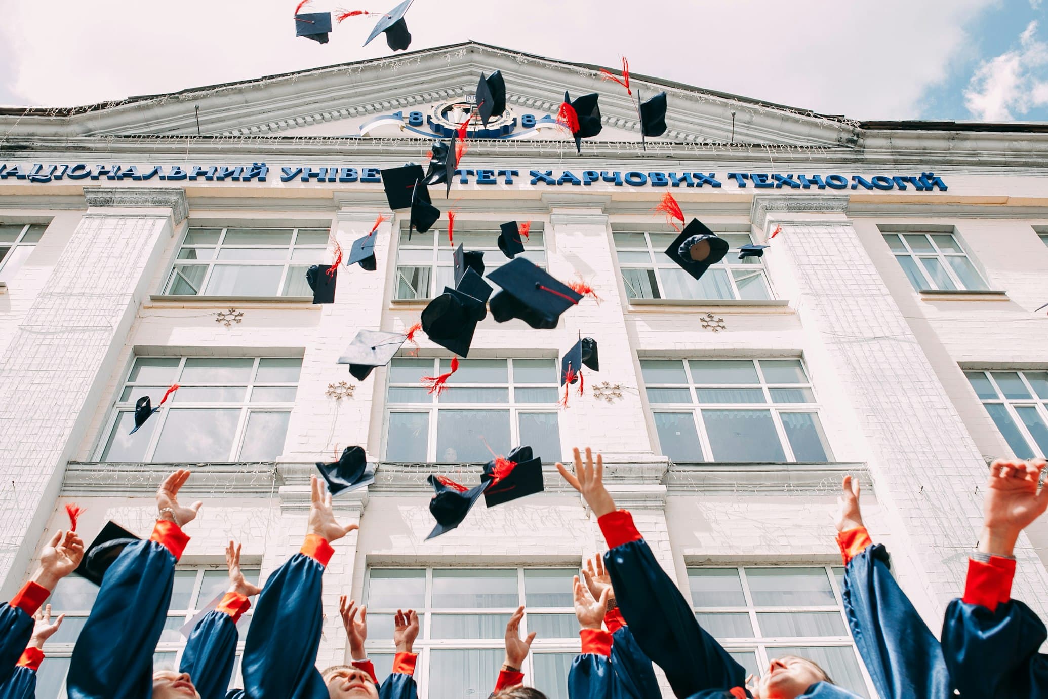 Students celebrating graduation at a university campus